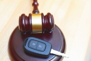 Judge's gavel resting beside a car key, illustrating DUI defense cases handled by Simmrin Law Group