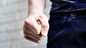 Close-up of a clenched fist, representing the assault charges defended by Simmrin Law Group